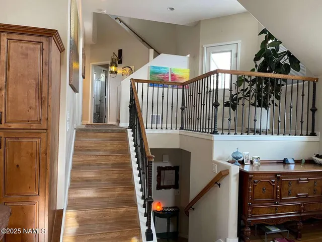 a view of entryway and hall with wooden floor