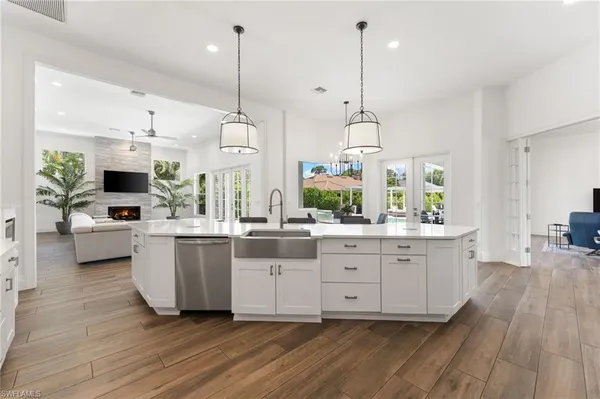 a spacious bedroom with a bed a table and chair