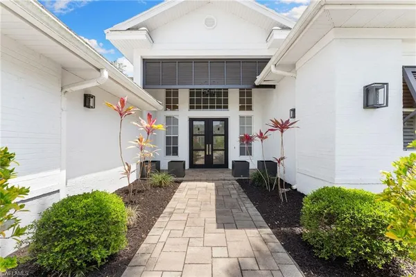 a spacious bedroom with a bed and a dresser