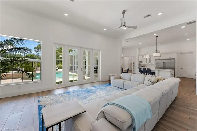 a spacious bedroom with a bed a table and chair