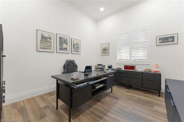 a view of a livingroom with wooden floor a fireplace and window