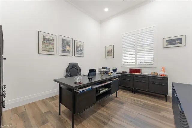 a view of a dining room with furniture wooden floor and chandelier