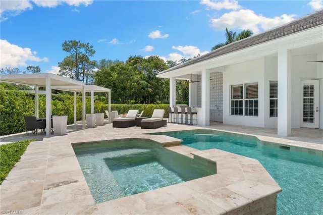 a view of a house with backyard sitting area and garden