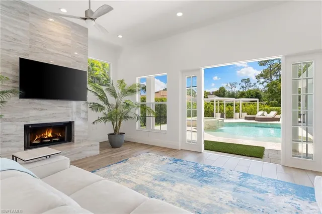 a living room with furniture a flat screen tv and a fireplace