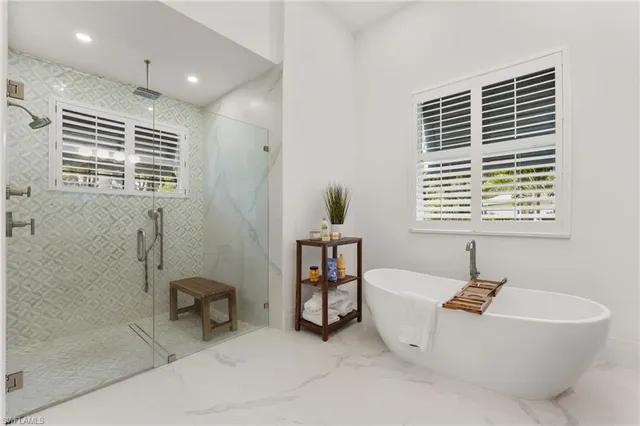 a bathroom with a bathtub and a shower