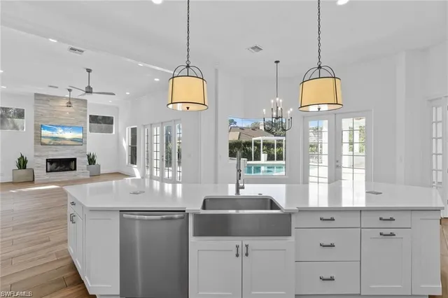 a bathroom with a sink a vanity a mirror and window