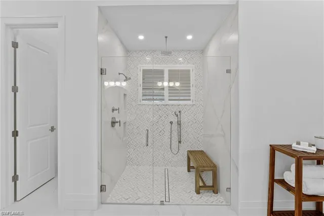 a large kitchen with white cabinets a sink dishwasher a dining table chairs and wooden floor