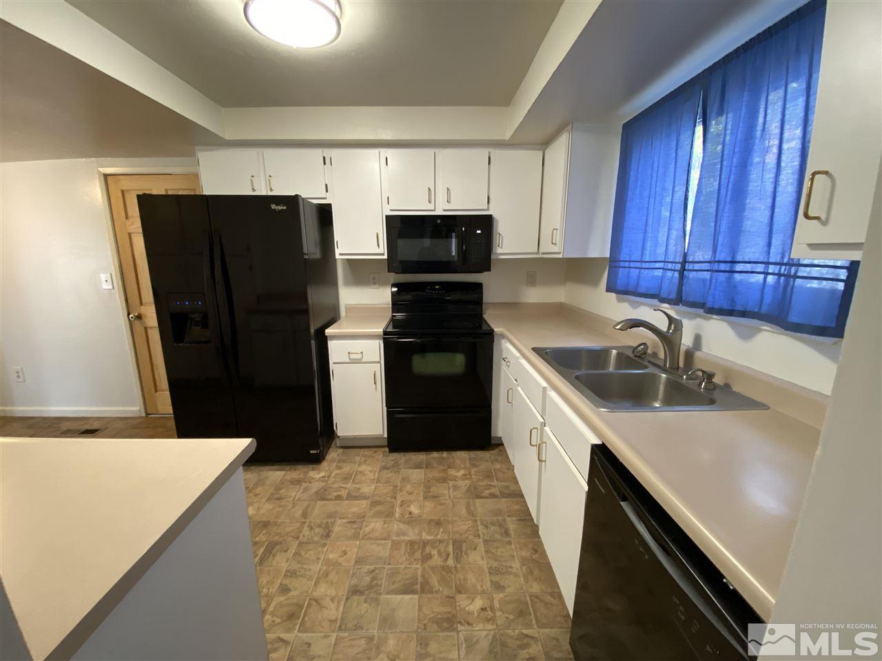 1107 Frontier Court Reno, NV 89503 - Photo 7 of 15 a kitchen with a refrigerator and a sink
