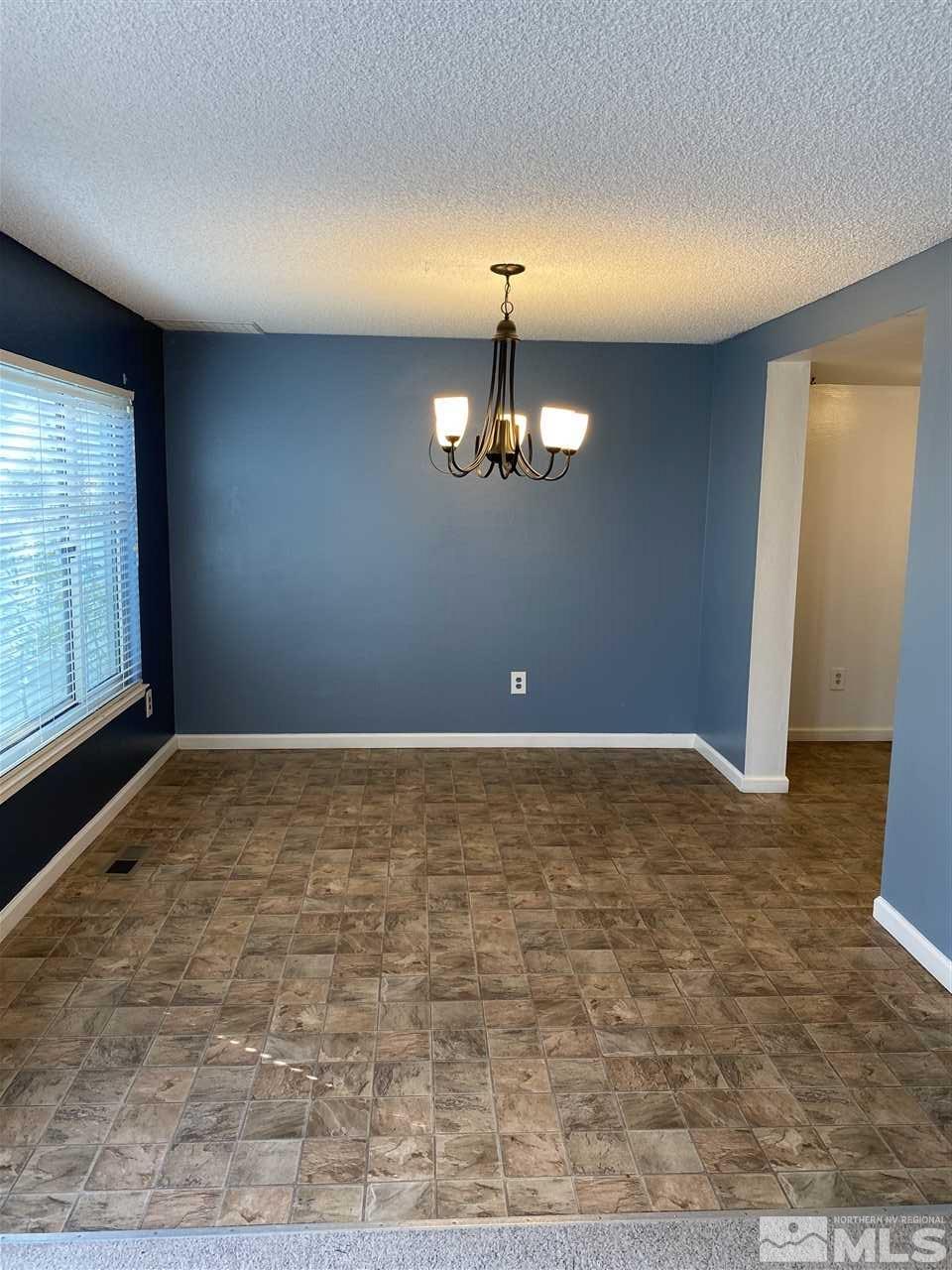 1107 Frontier Court Reno, NV 89503 - Photo 9 of 15 a view of an empty room with window and chandelier fan