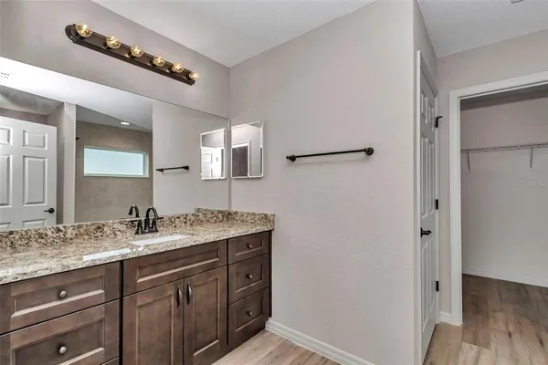 a bathroom with a double vanity sink and mirror