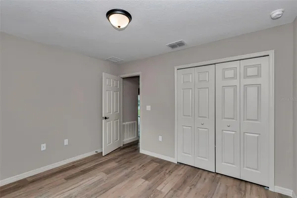 a view of an empty room and wooden floor