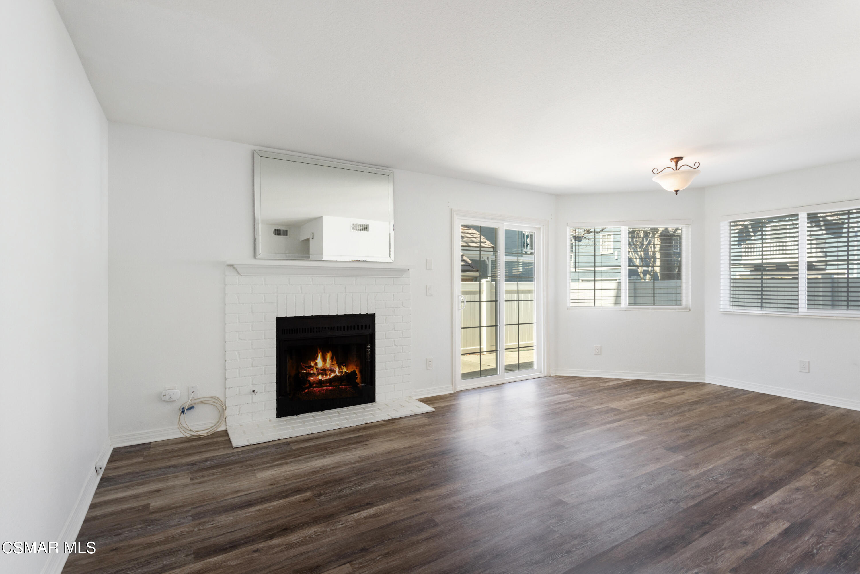 1962 Rory Lane, Unit 2 Simi Valley, CA 93063 - Photo 3 of 21 a living room with a fireplace and wooden floor