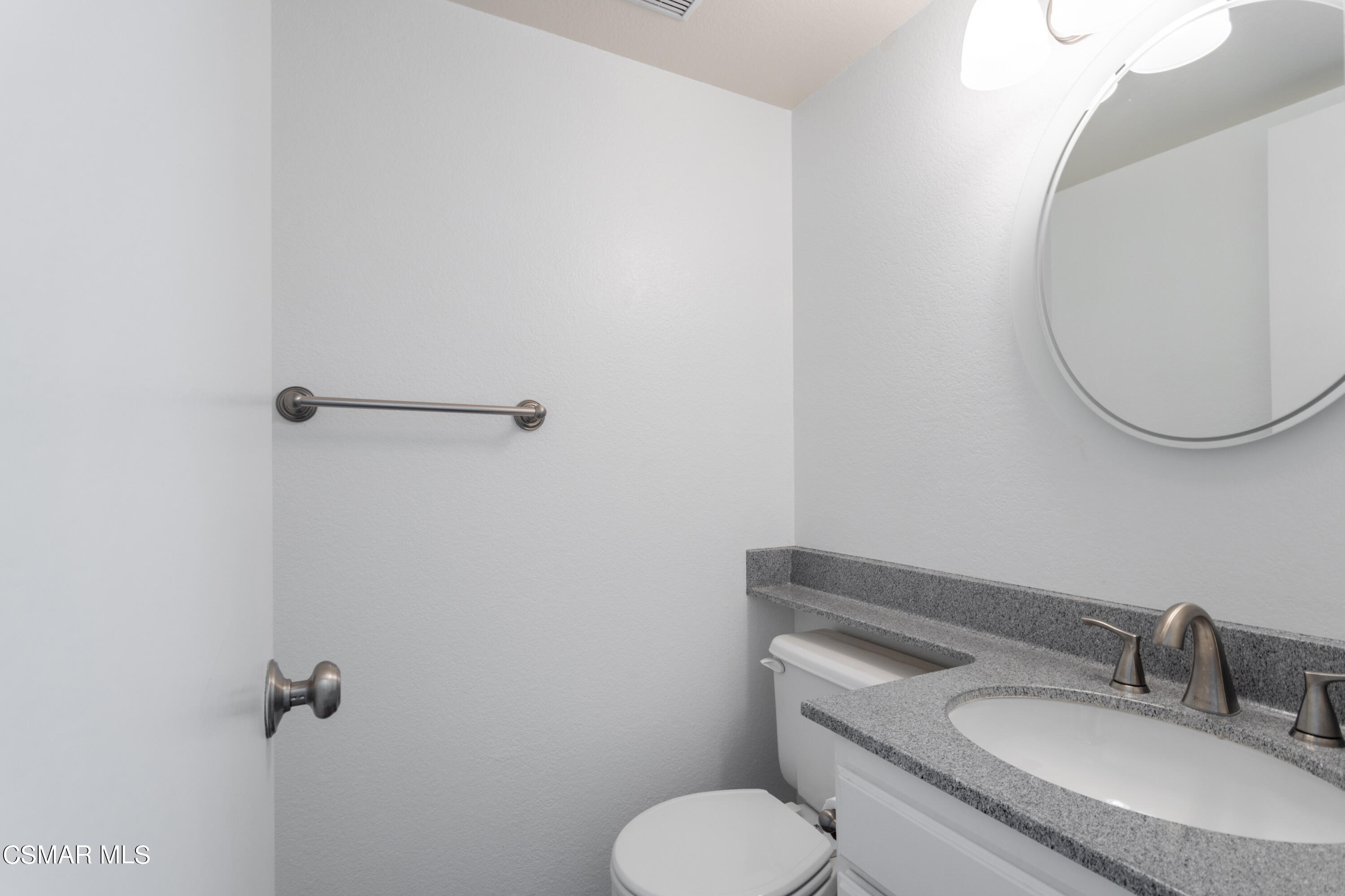 1962 Rory Lane, Unit 2 Simi Valley, CA 93063 - Photo 9 of 21 a bathroom with a granite countertop toilet sink and mirror