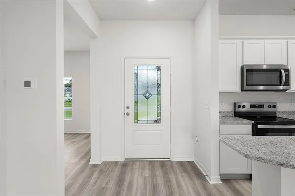 a kitchen with a refrigerator and a stove top oven