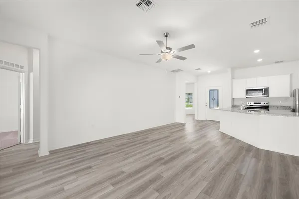 a view of a kitchen with a sink and a stove top oven
