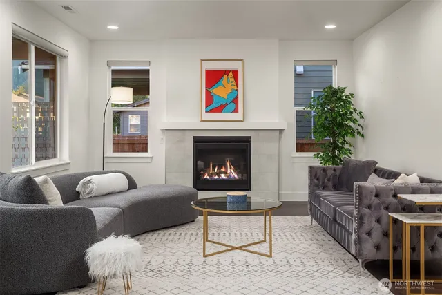 a living room with furniture and a fireplace