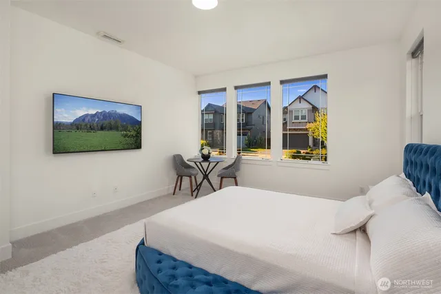 a bedroom with a bed and glass wall painting