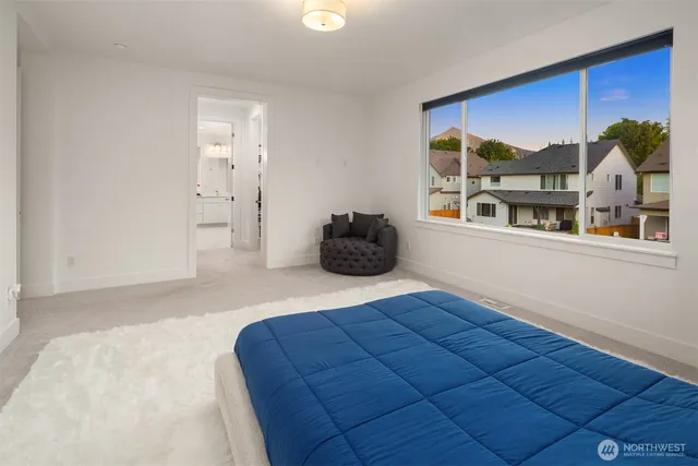 a bedroom with a bed and a large window