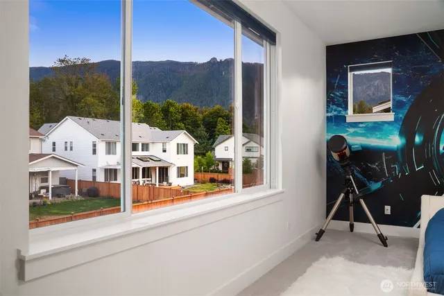 a view of a balcony with chairs and a yard