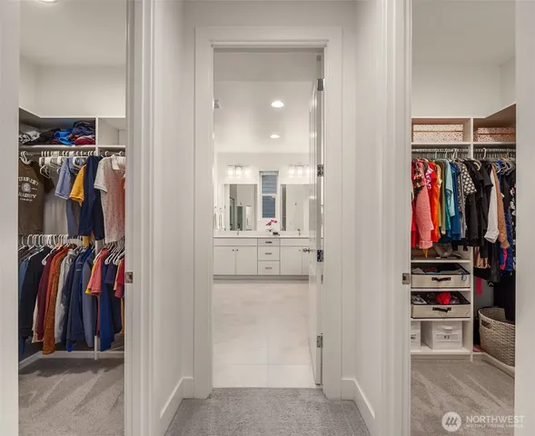 a view of walk in closet with clothes and shoes