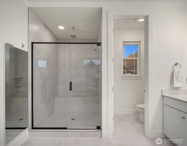 a bathroom with a shower and a toilet