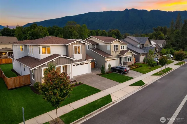 an aerial view of multiple houses with a yard