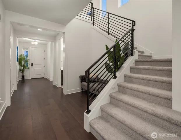 a view of entryway and hall with wooden floor
