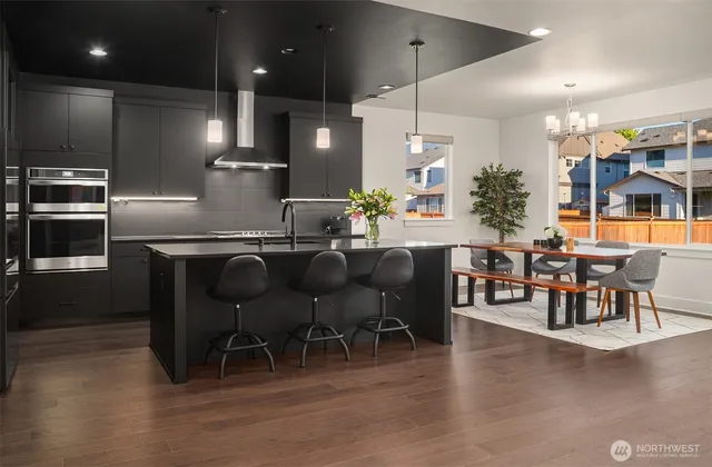 a large kitchen with a table and chairs