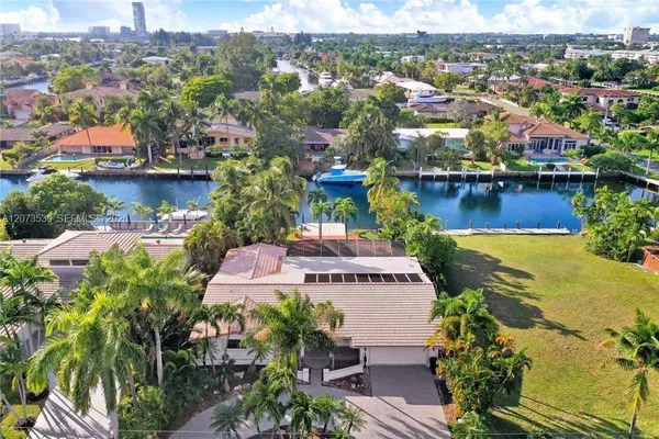 an aerial view of residential houses with outdoor space and swimming pool