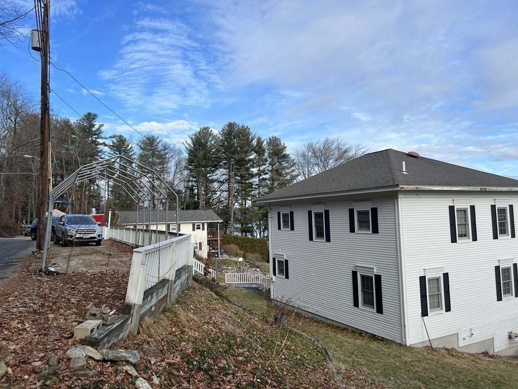 7 South Charlton Shore Road Charlton, MA 01507 - Photo 17 of 42 a view of a white house with a yard and outdoor seating