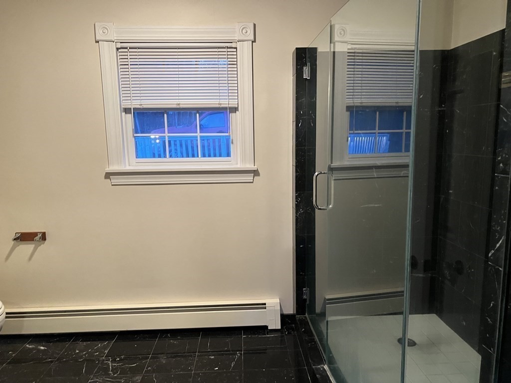 7 South Charlton Shore Road Charlton, MA 01507 - Photo 22 of 42 a bathroom with a bathtub and a window