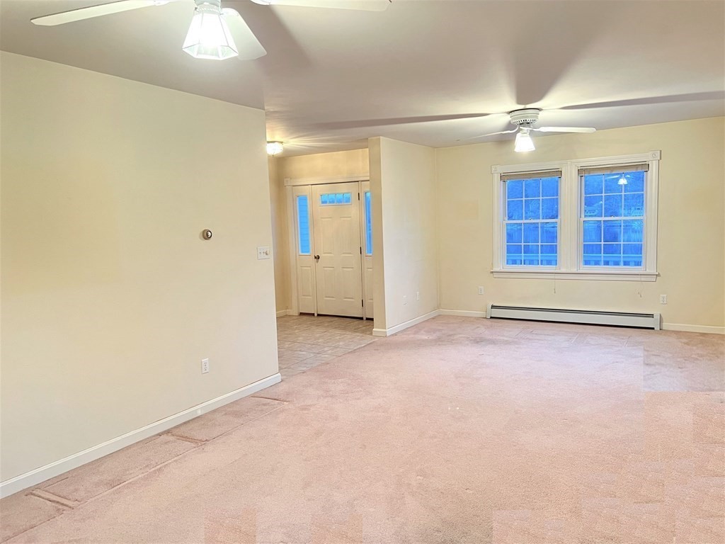 7 South Charlton Shore Road Charlton, MA 01507 - Photo 32 of 42 an empty room with chandelier fan and windows