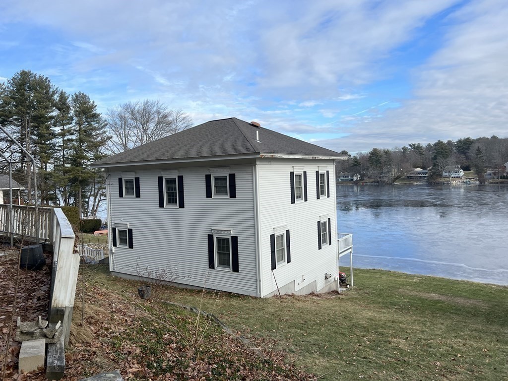 7 South Charlton Shore Road Charlton, MA 01507 - Photo 4 of 42 a view of a white house next to a yard with big trees