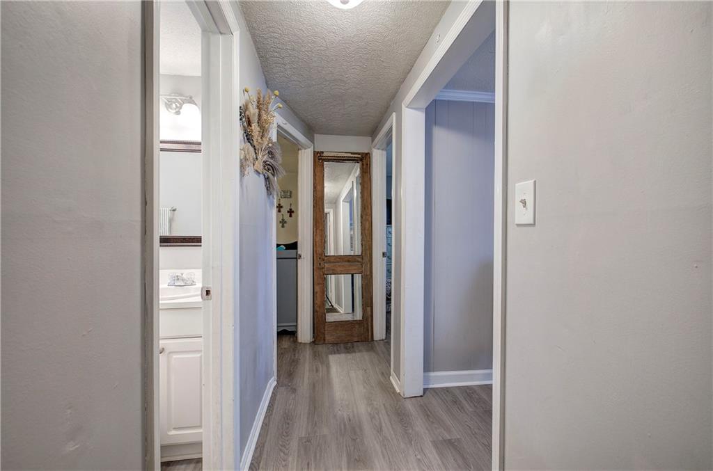 2023 Fate Conn Road Canton, GA 30114 - Photo 14 of 59 a view of a hallway with wooden floor and closet
