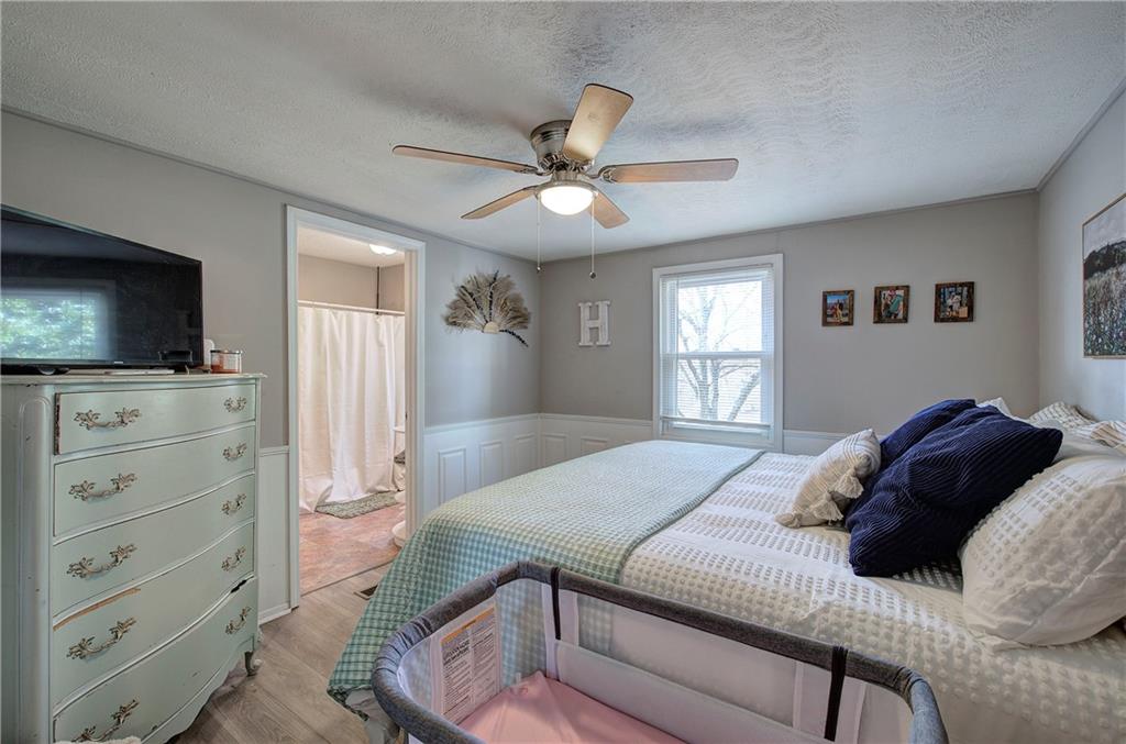 2023 Fate Conn Road Canton, GA 30114 - Photo 15 of 59 a bedroom with a bed and a flat screen tv