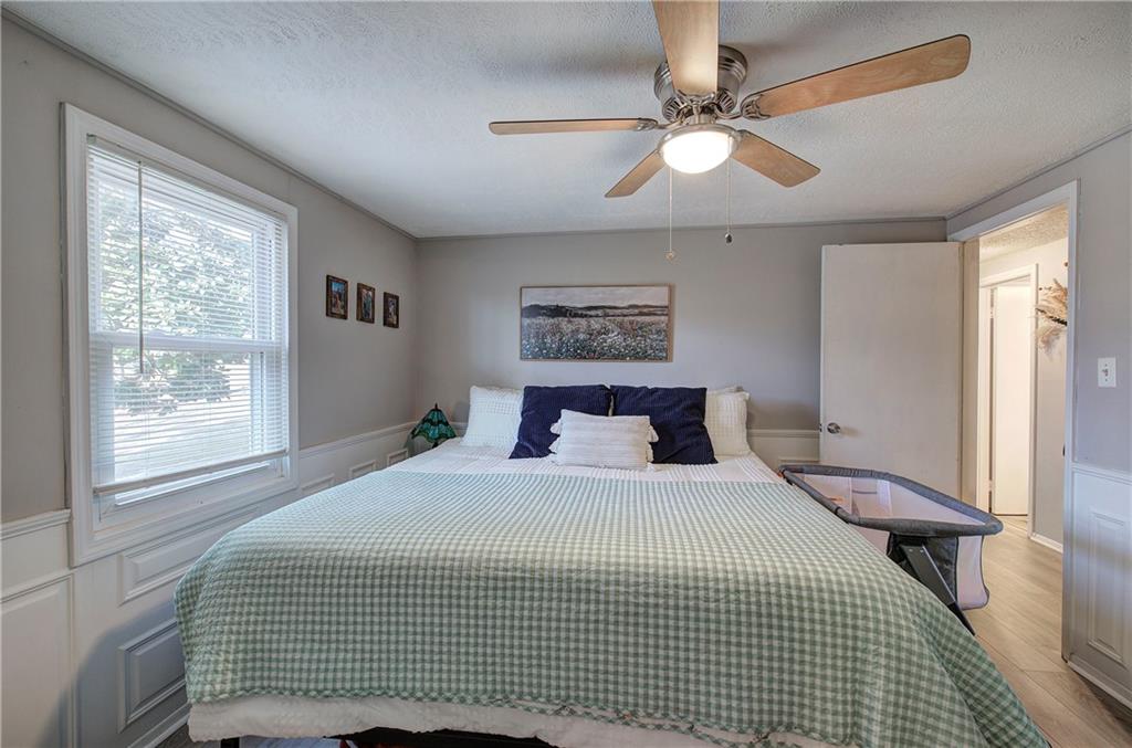 2023 Fate Conn Road Canton, GA 30114 - Photo 16 of 59 a bedroom with a large bed and a chandelier