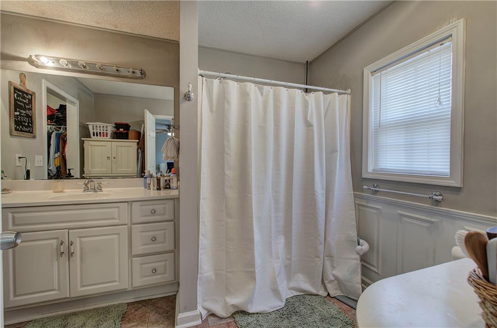 2023 Fate Conn Road Canton, GA 30114 - Photo 17 of 59 a bathroom with a granite countertop sink vanity mirror and toilet