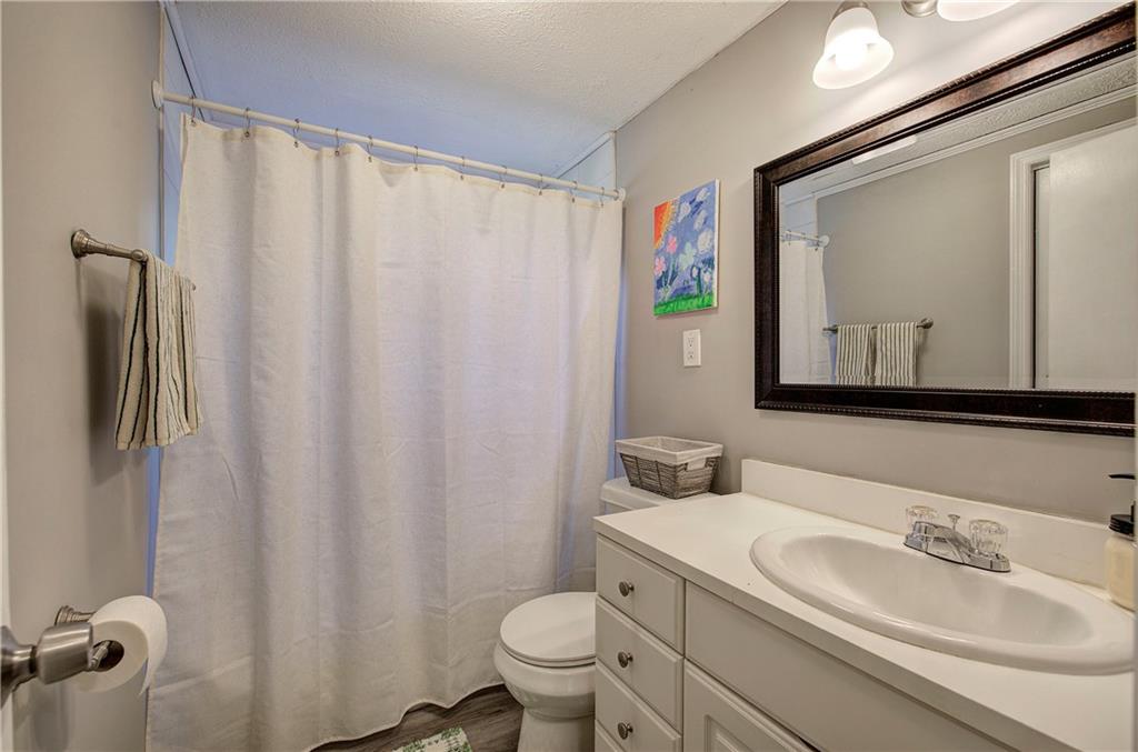 2023 Fate Conn Road Canton, GA 30114 - Photo 22 of 59 a bathroom with a sink vanity mirror and toilet