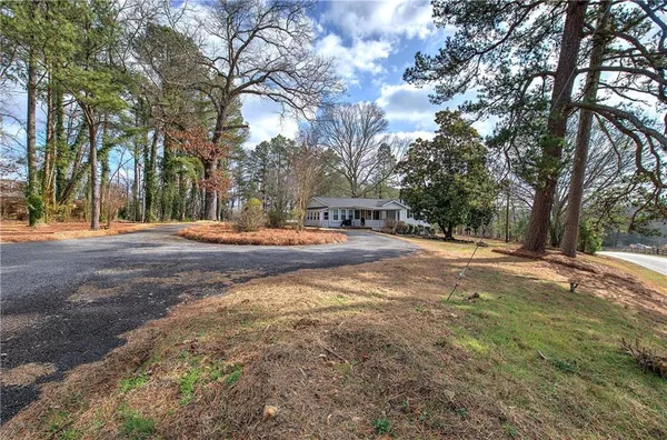 an aerial view of a house with a yard