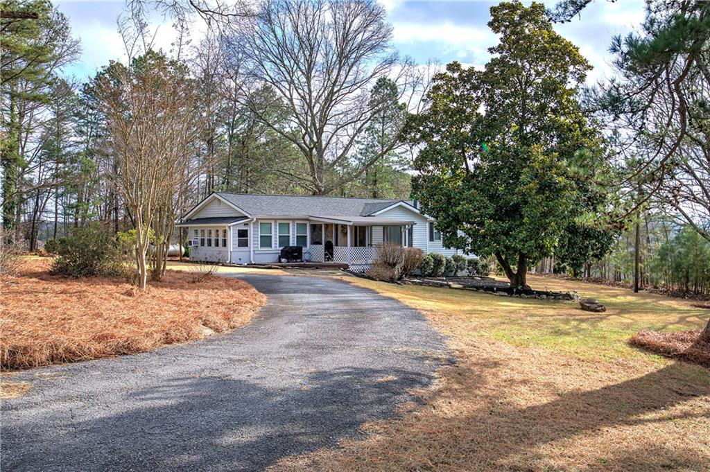 2023 Fate Conn Road Canton, GA 30114 - Photo 48 of 59 a front view of a house with yard patio and tree