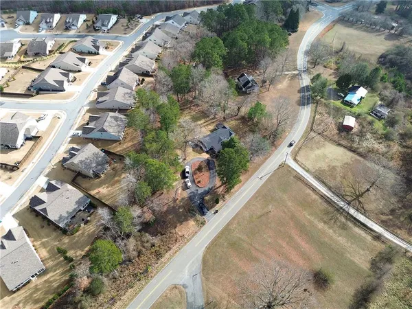 an aerial view of residential houses with outdoor space