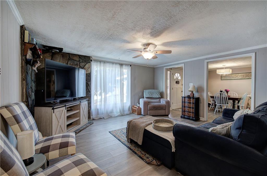 2023 Fate Conn Road Canton, GA 30114 - Photo 5 of 59 a living room with furniture and a flat screen tv