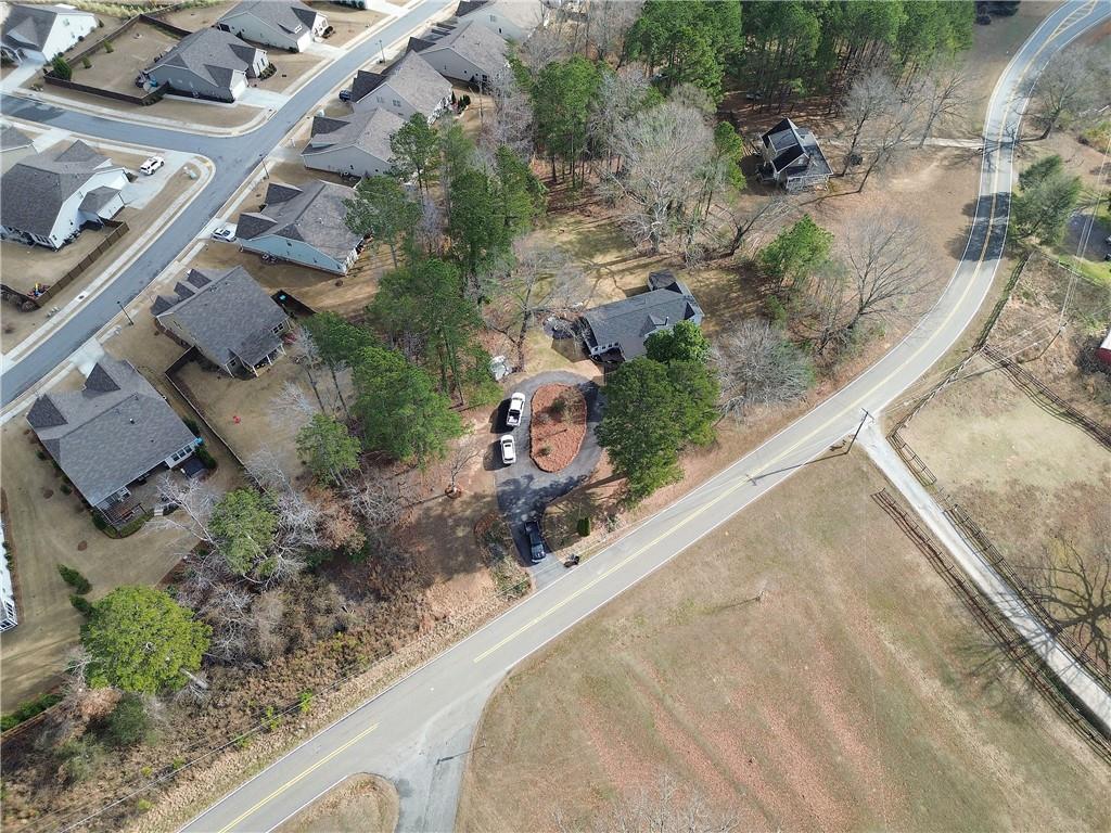 2023 Fate Conn Road Canton, GA 30114 - Photo 55 of 59 an aerial view of a house with a yard and parking spaces