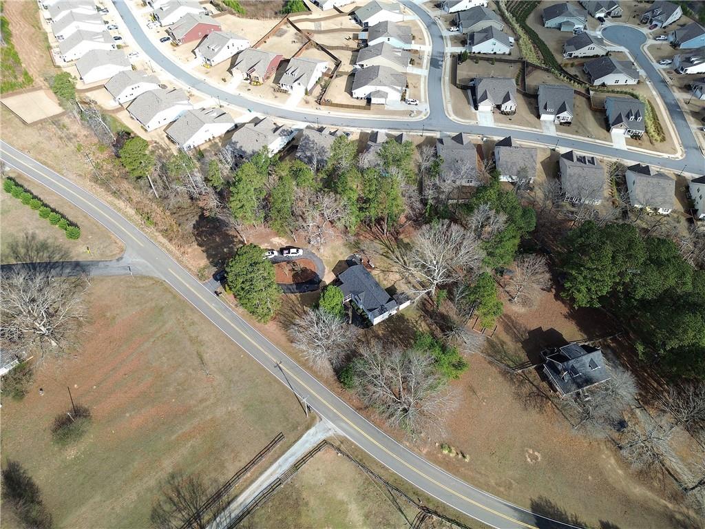 2023 Fate Conn Road Canton, GA 30114 - Photo 58 of 59 an aerial view of a house with a yard and greenery