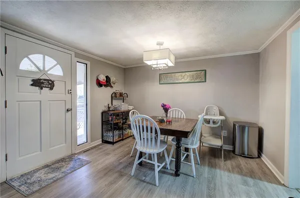 a view of a dining room with furniture and wooden floor