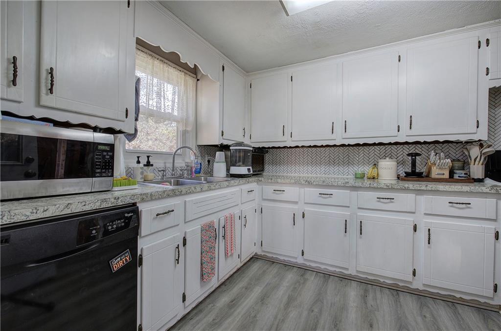 2023 Fate Conn Road Canton, GA 30114 - Photo 9 of 59 a kitchen with granite countertop white cabinets and white appliances