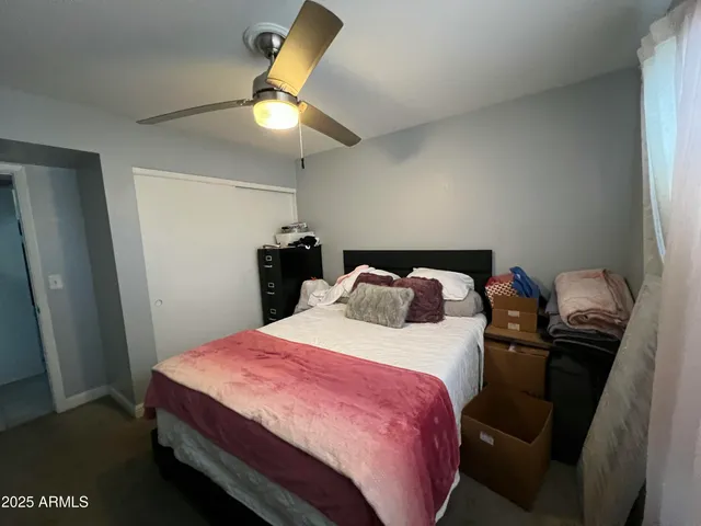 a spacious bedroom with a bed and a chandelier