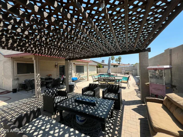 a kitchen with stainless steel appliances kitchen island granite countertop a dining table and chairs