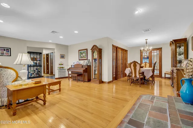 a living room with furniture and a dining table with rug floor