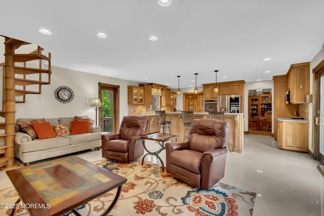 a living room with furniture kitchen view and a refrigerator